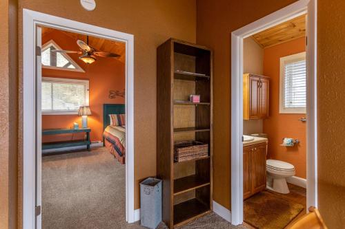 a bathroom with a toilet and a bedroom at Grand Panorama in Banner Elk