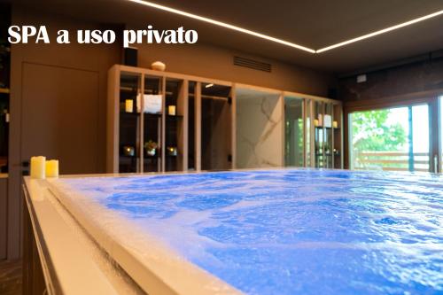 a large pool of blue water in a room at AL TIGLIO in Farra di Soligo