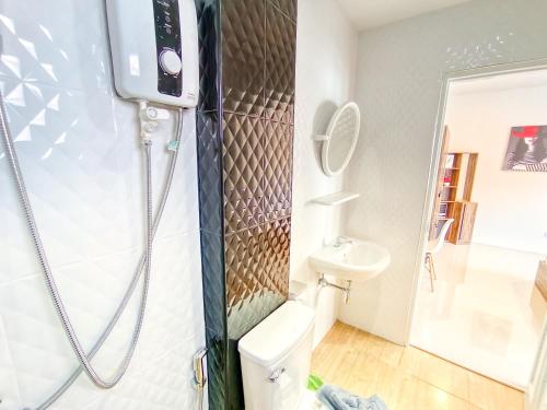 a bathroom with a shower and a toilet at Sailor Hotel Pattaya in Pattaya South