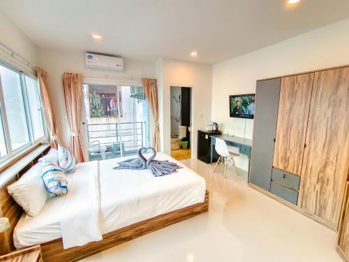 a bedroom with a bed and a desk at Sailor Hotel Pattaya in Pattaya South