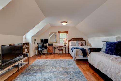 a bedroom with a bed and a desk and a tv at The Wander Inn in Blowing Rock