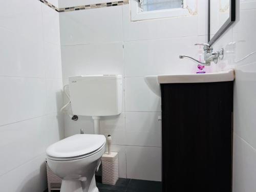 a bathroom with a white toilet and a sink at New - Luxury Studio 3 Minutes From Beach ! in Tel Aviv