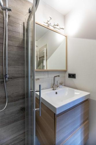 a bathroom with a sink and a mirror at Ferienwohnung Merle in Wyk auf Föhr