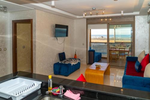 a living room with a view of the ocean at PUERTO MARINA ASILAH in Asilah