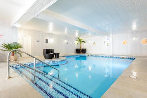 a large swimming pool in a room at Barrowfield Hotel in Newquay