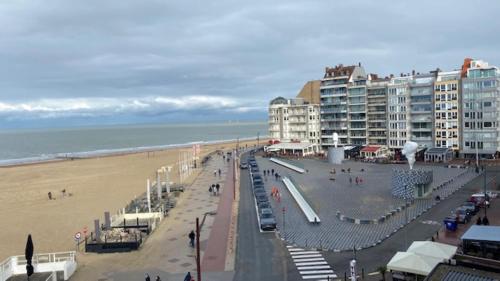 a view of a beach with buildings and the ocean at Royal Knokke in Knokke-Heist