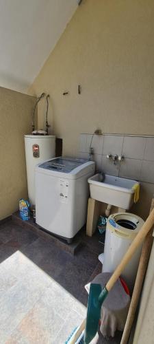 a bathroom with a sink and a toilet in a room at Alojamiento La Floresta, 3 ambientes para 5 personas in Buenos Aires
