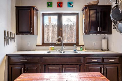 a kitchen with a sink and a window at Pueblo Revival in Taos
