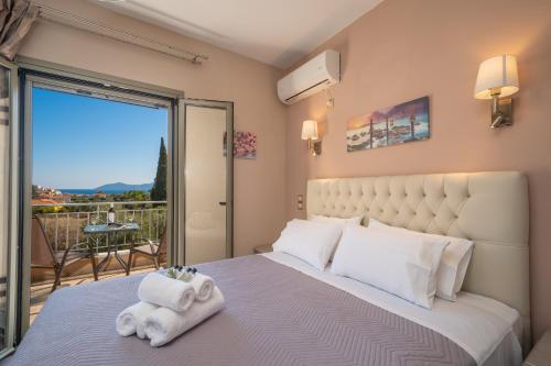 a bedroom with a large bed with towels on it at Family Villa Citrine Kefalonia - near Agia Efimia in Agia Effimia