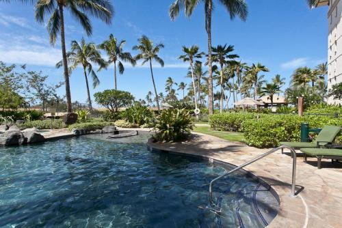 a swimming pool with a hose in a resort at Luxury 2BR 2BA Ko Olina Beach Villa O410- Sleeps 6 Steps to Lagoon & Aulani in Kapolei