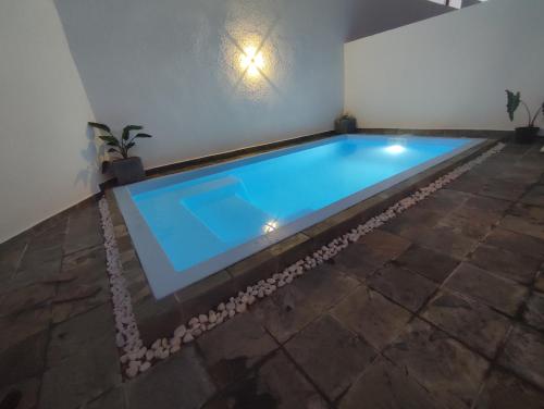 a swimming pool in the middle of a room at Golden Square Villa & Private Pool in Flic-en-Flac