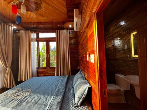 a bedroom with a bed and a sink in a room at Mountain House Phú Quốc in Phu Quoc