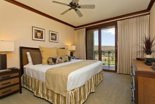 a bedroom with a large bed and a balcony at Ko Olina Beach Villas O1002 - 3BR Luxury Condo with Stunning Ocean View & 2 Free Parking in Kapolei