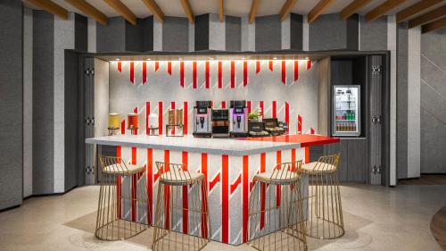 a lobby with a bar with red and white stripes at Hotel Indigo Alishan by IHG in Fanlu