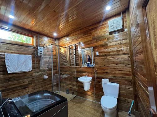 a bathroom with a toilet and a sink and a tub at Mountain House Phú Quốc in Phu Quoc