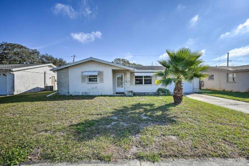 a palm tree in the yard of a house at Cozy Holiday Home with Yard about 5 Mi to Beach! in Holiday