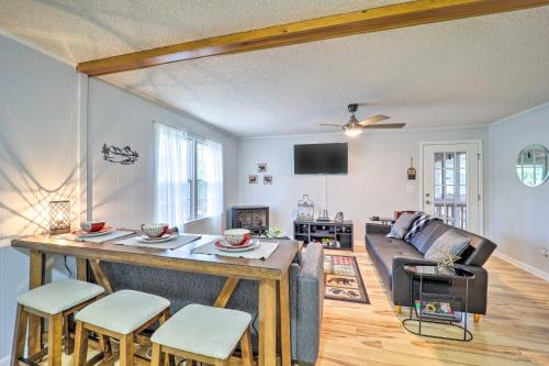 a living room with a table and a couch at In Golf Community with Pool Access Newland Cabin in Newland
