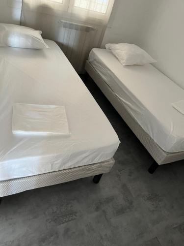 deux lits côte à côte dans une pièce dans l'établissement Bandol le grand horizon, à Bandol