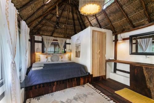 a bedroom with a bed in a house at Villa Santuario Lake front Oasis in Bacalar