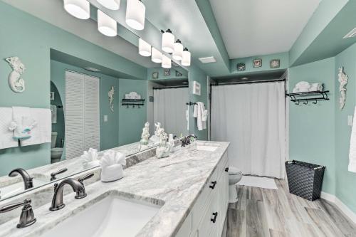 a bathroom with two sinks and a large mirror at Sunlit St Petersburg Condo with Community Pool in St Petersburg