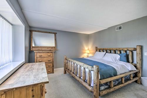 a bedroom with a wooden bed and a mirror at Escondido Hilltop Home with Deck and Views! in Escondido