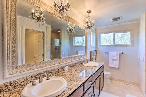 a bathroom with two sinks and a large mirror at Tacoma Home with Garden and Pond about 3 Mi to Beach! in Tacoma
