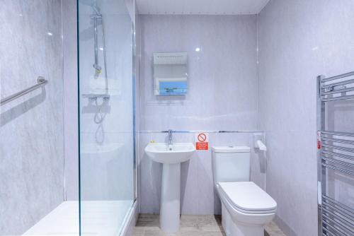 a bathroom with a toilet and a sink and a shower at The Lakeland Kendal Hotel, Sure Hotel Collection by Best Western in Kendal
