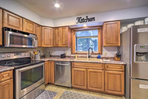 a kitchen with wooden cabinets and stainless steel appliances at Lakefront Chetek Haven Dock, Screened Gazebo in Chetek