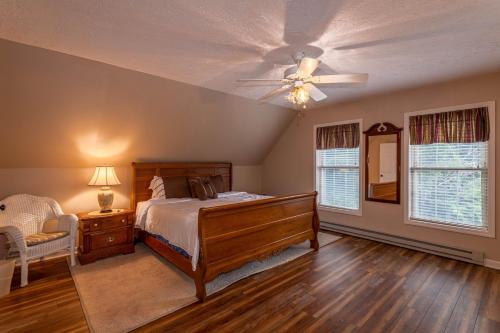 a bedroom with a bed and a ceiling fan at Adventure Awaits in Seven Devils