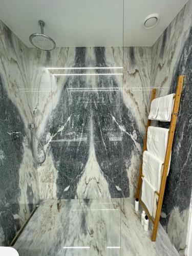 a bathroom with a marble wall at Sea&River Apartment in Vila Nova de Gaia