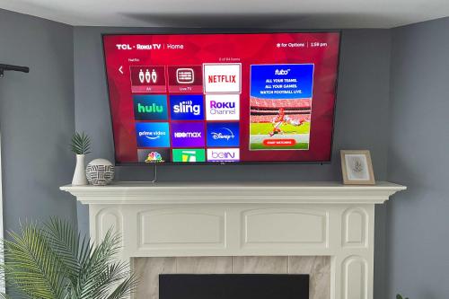 a flat screen tv sitting on top of a fireplace at Annapolis Vacation Home 2 Mi to Quiet Waters Park in Annapolis