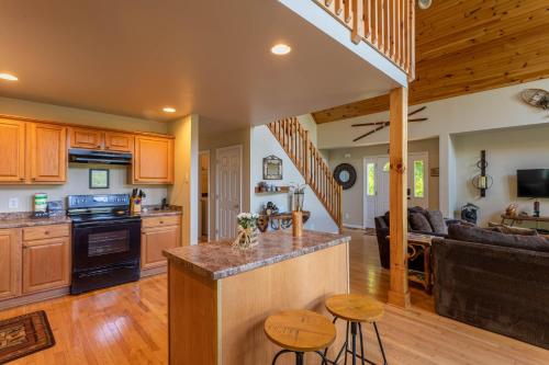 a kitchen and living room with wooden cabinets at 4 Bears Lodge in Banner Elk
