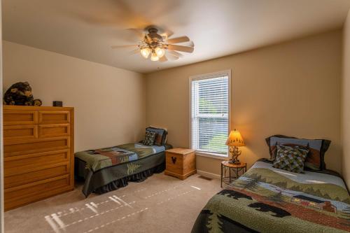 a bedroom with two beds and a ceiling fan at 4 Bears Lodge in Banner Elk