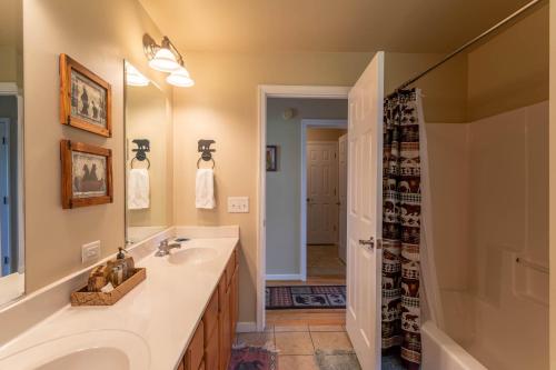 a bathroom with a sink and a mirror and a shower at 4 Bears Lodge in Banner Elk