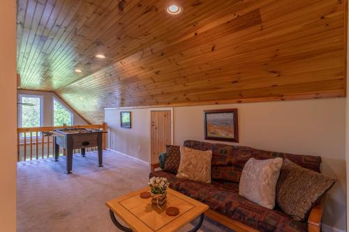 a living room with a couch and a piano at 4 Bears Lodge in Banner Elk