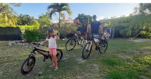 a group of people with bikes in a yard at Moana Breeze Rangiroa - Rental car included - Air conditioning - WI-Fi in Tiputa