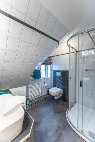 a bathroom with a shower and a sink and a toilet at Dat Südstrandhuus- Ferienwohnung Silke in Wyk auf Föhr