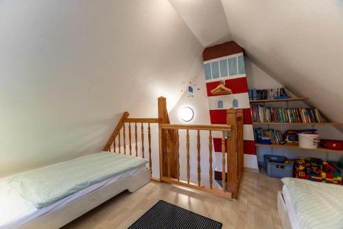 a childs bedroom with a crib and a lighthouse shelf at Dat Südstrandhuus- Ferienwohnung Silke in Wyk auf Föhr