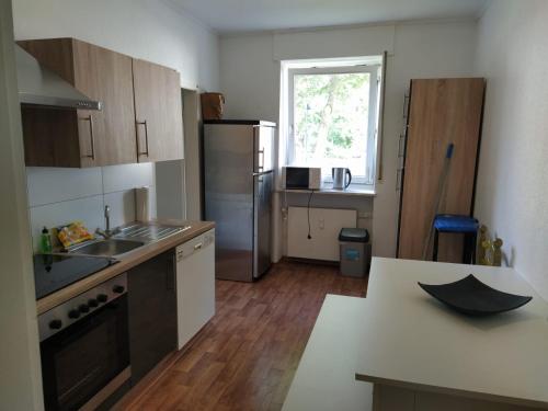 a kitchen with a sink and an umbrella on the counter at Schöne Ferienwohnung in Becheln in Becheln