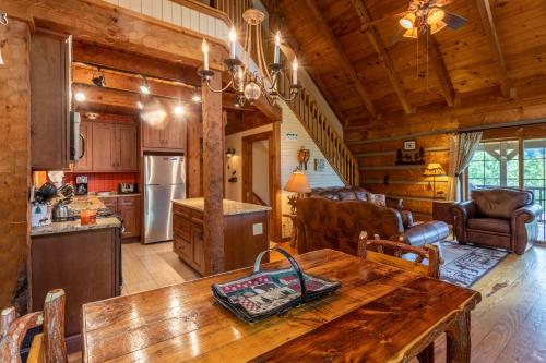 a kitchen and living room with a table in a cabin at Moose Preserve in Sugar Grove