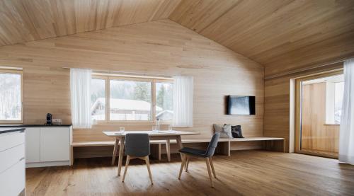 a kitchen and dining room with a table and chairs at Gabriela Apartments in Mellau