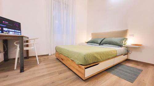 a bedroom with a bed and a television in it at Casa Volsci, 2 camere 2 bagni, Roma centro in Rome