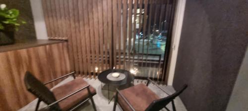 a room with chairs and a table and a window at Hotel Zlatna Žita in Pale