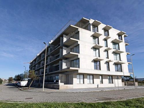 a large white building on the side of a street at Sea&River Apartment in Vila Nova de Gaia