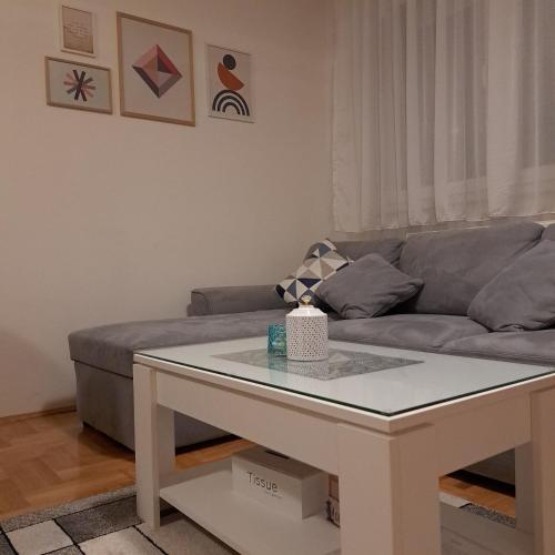 a living room with a couch and a white coffee table at On Top 21 in Bijeljina