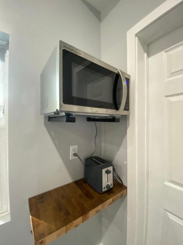 a television on a shelf in a room at The Front Porch in Sanford