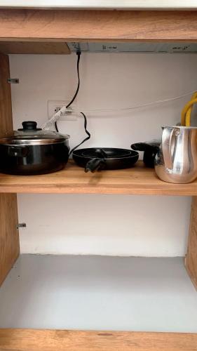a shelf with some pots and pans on it at Aloja-T en Apartamento amoblado 5 con balcón en Ciudad Bolivar in Ciudad Bolívar