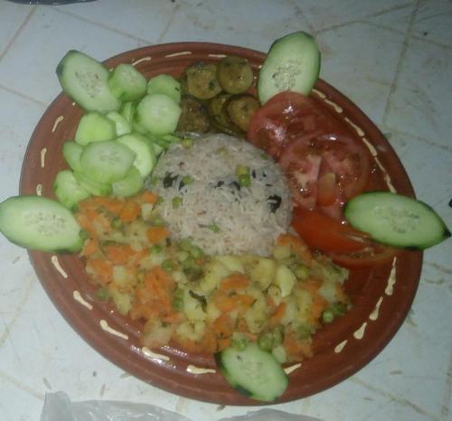 a plate of food with cucumbers and vegetables on it at Bivouac Beauté de Désert in Mhamid