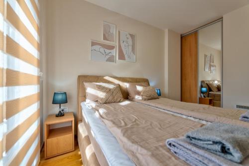 1 dormitorio con 1 cama grande y espejo en Stek Hills Zlatibor, en Zlatibor