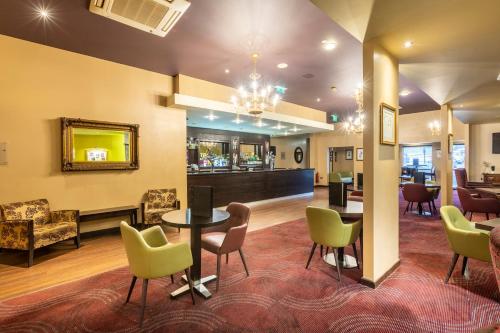 a lobby with a table and chairs and a bar at Gloucester Robinswood Hotel, BW Signature Collection in Gloucester